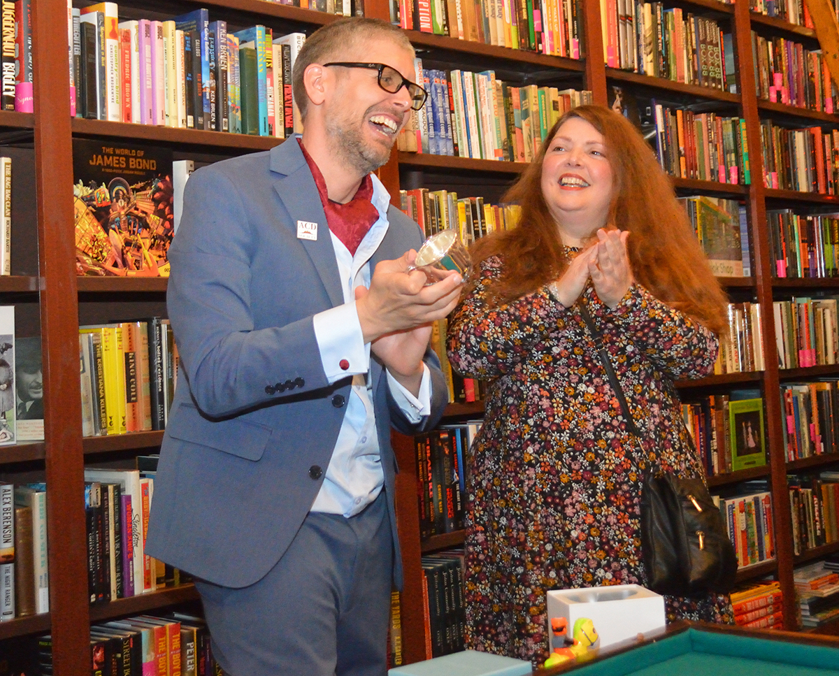 Derrick Belanger and Peggy McFarlane inside The Mysterious Bookshop during the 2023 Wessex Cup event